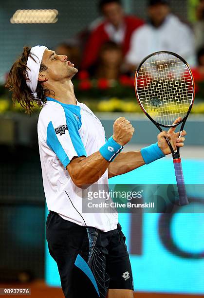 David Ferrer of Spain celebrates match point against Jeremy Chardy of France in their first round match during the Mutua Madrilena Madrid Open tennis...
