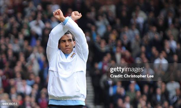 Carlos Tevez of Man City gives a Hammers sign to the West Ham fans as they cheer his name during the Barclays Premier League match between West Ham...