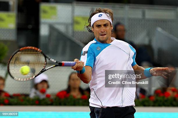 David Ferrer of Spain plays a forehand against Jeremy Chardy of France in their first round match during the Mutua Madrilena Madrid Open tennis...