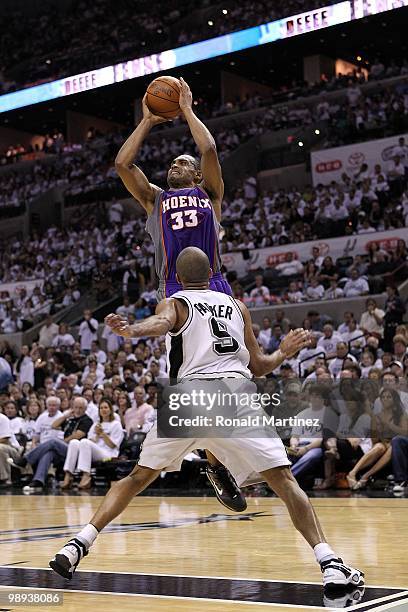 Forward Grant Hill of the Phoenix Suns takes a shot against Tony Parker of the San Antonio Spurs in Game Three of the Western Conference Semifinals...