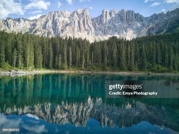 lake carezza and latemar, south tyrol, italy - gebirgskette latemar stock-fotos und bilder