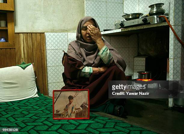 Hafiza shows the photograph of one of her dead sons inside her home on May 09, 2010 in Islamabad, 56 Kms south of Srinagar, the summer capital of...