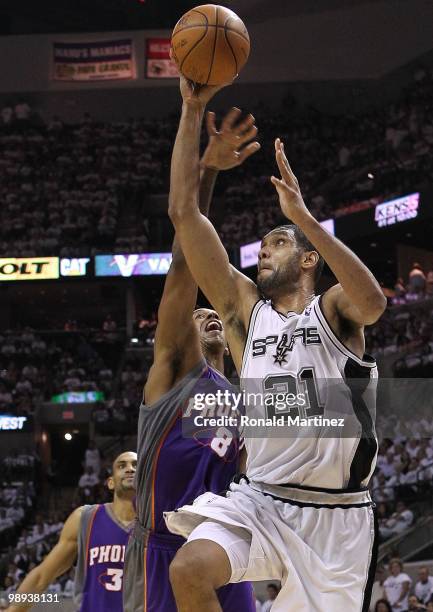 Forward Tim Duncan of the San Antonio Spurs takes a shot against Channing Frye of the Phoenix Suns in Game Three of the Western Conference Semifinals...