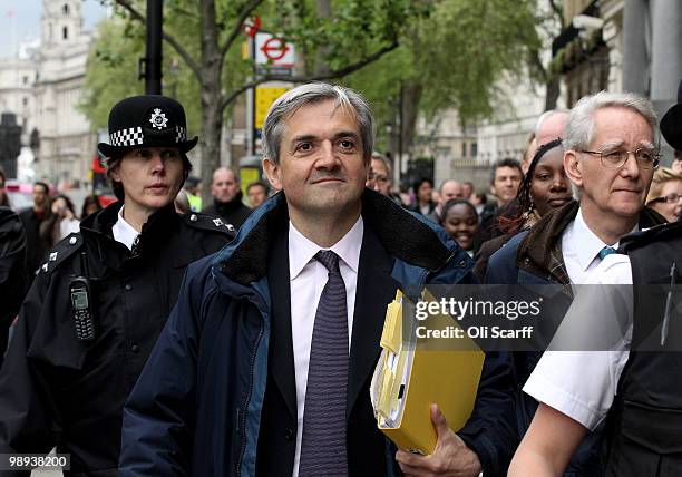 Liberal Democrats Shadow Home Secretary Chris Huhne leaves the Cabinet Office following talks with a team of senior figures from the Conservatives...