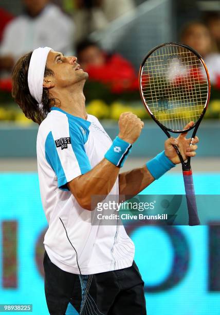 David Ferrer of Spain celebrates match point against Jeremy Chardy of France in their first round match during the Mutua Madrilena Madrid Open tennis...