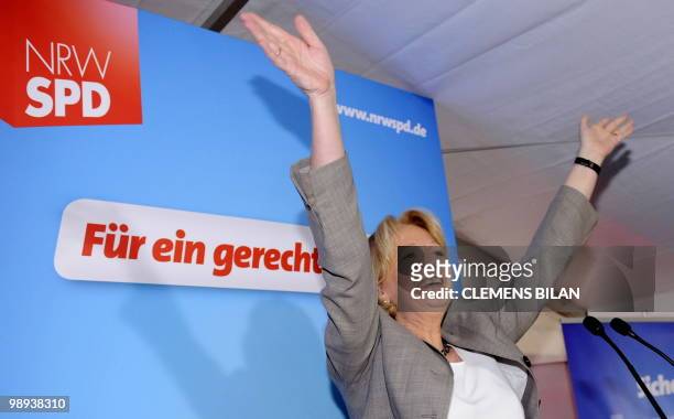 The Social Democrats main candidate Hannelore Kraft celebrates as she addresses her supporters after exit poll resuts were announced on state...
