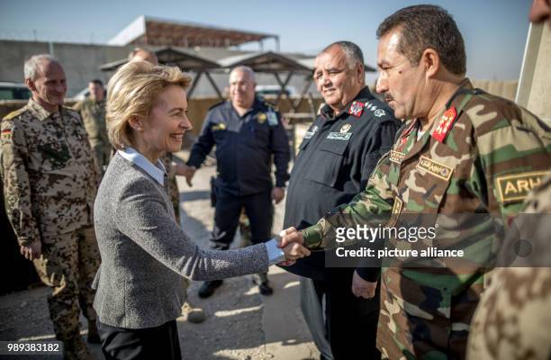 General Amanullah Mobeen of the Afghan National Army greets German Defence Minister Ursula von der Leyen in the military camp Marmal in...