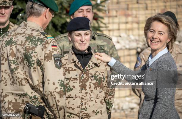 German Defence Minister Ursula von der Leyen laughs while naming an officer lieutenant colonel in the military camp Marmal in Masar-i-scharif in...