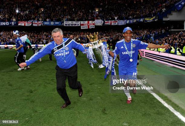 Chelsea's manager Carlo Ancellotti and Florent Malouda celebrate with the trophy after winning the league with an 8-0 victory during the Barclays...