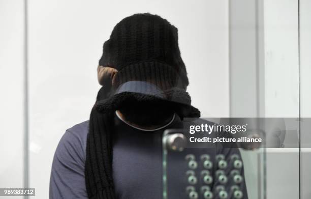 Radical Iraqi preacher and IS main recruiter in Germany, Abu Walaa, covers his face as he arrives for his trial at the Higher Regional Court in...