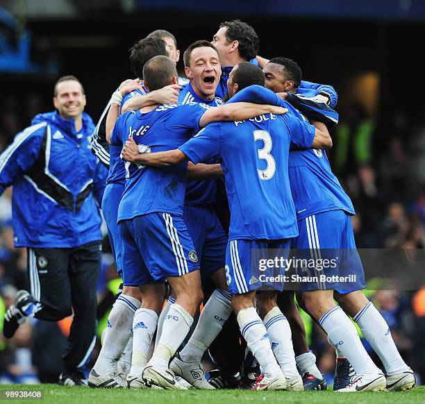 John Terry of Chelsea celebrates with team mates as they win the title after the Barclays Premier League match between Chelsea and Wigan Athletic at...