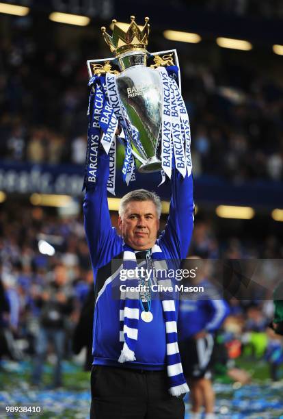 Carlo Ancelotti manager of Chelsea celebrates with the trophy as they win the title after the Barclays Premier League match between Chelsea and Wigan...