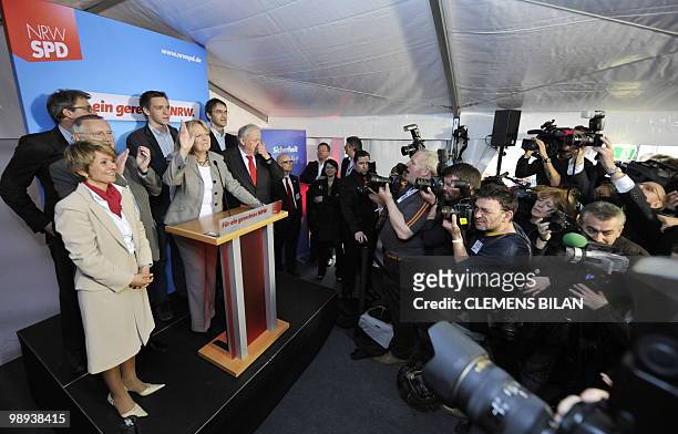 The Social Democrats main candidate Hannelore Kraft celebrates as she addresses journalists after exit poll resuts were announced on state television...