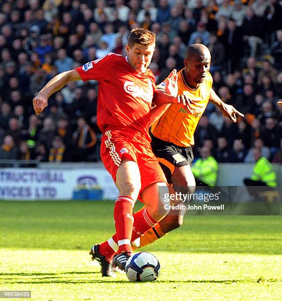 Steven Gerrard of Liverpool competes with Anthony Gardner of Hull City during the Barclays Premier League match between Hull City and Liverpool at KC...