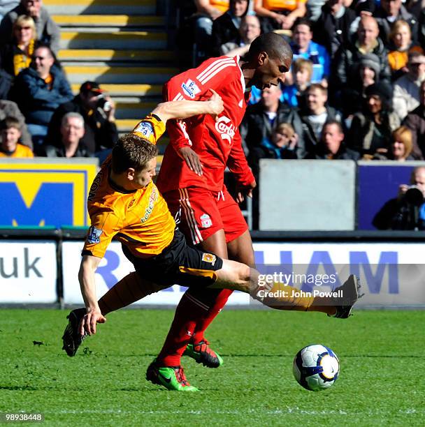 Andy Dawson of Hull City takes out Ryan Babel of Liverpool during the Barclays Premier League match between Hull City and Liverpool at KC Stadium on...