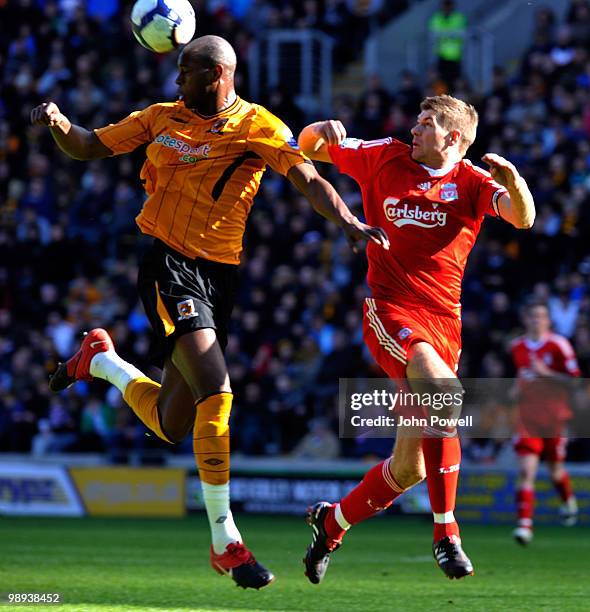 Steven Gerrard of Liverpool competes with Anthony Gardner of Hull City during the Barclays Premier League match between Hull City and Liverpool at KC...