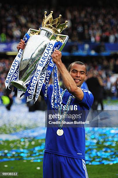 Ashley Cole of Chelsea celebrates with the trophy as they win the title after the Barclays Premier League match between Chelsea and Wigan Athletic at...