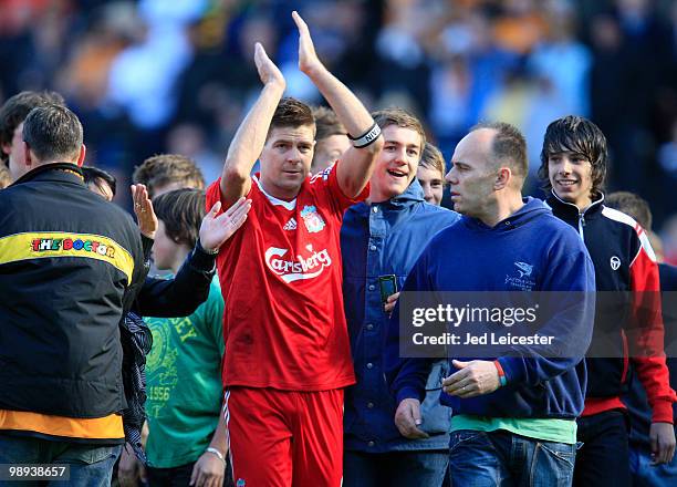 Surrounded by Hull City fans who invaded the pitch at fulltime, Steven Gerrard of Liverpool makes his way to the away fans to thank them after the...