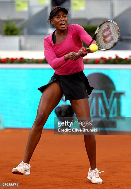 Venus Williams of the USA plays a backhand against Stefanie Voegele of Switzerland in their first round match during the Mutua Madrilena Madrid Open...