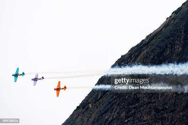 Three T6 Texan, Skywriting "Oi" perform during the Red Bull Air Race Day on May 9, 2010 in Rio de Janeiro, Brazil.