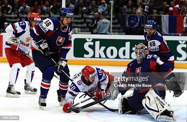 Vladimir Mihalik of Slovakia and Sergei Mozyanki of Russia battle for the puck during the IIHF World Championship group A match between Slovakia and...