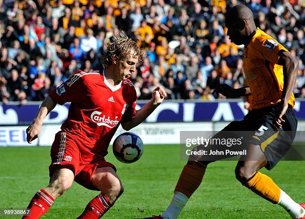 Dirk Kuyt of Liverpool competes with Anthony Gardner during the Barclays Premier League match between Hull City and Liverpool at KC Stadium on May 9,...