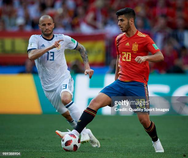 Marco Asensio of Spain competes for the ball with Fedor Kudriashov of Russia during the 2018 FIFA World Cup Russia Round of 16 match between Spain...