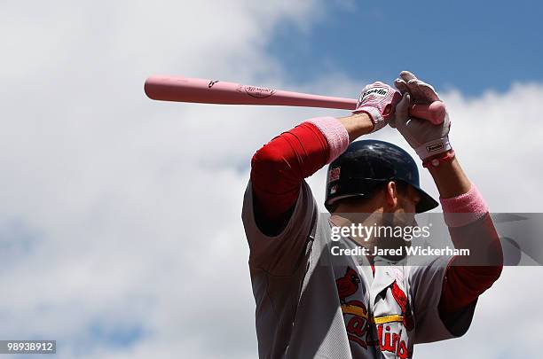 Joe Mather of the St. Louis Cardinals warms up in the on deck circle while using a pink bat on Mothers Day during the game against the Pittsburgh...