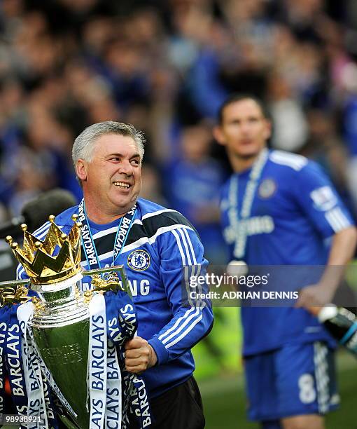 Chelsea's Italian manager Carlo Ancelotti celebrates with the Barclays Premier League trophy after Chelsea win the title with a 8-0 victory over...