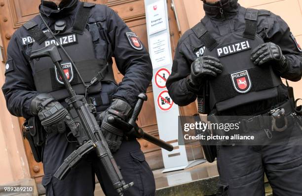 Police officers secure the entrance to the Higher Regional Court in Celle, Lower Saxony, Germany, 19 December 2017. The radical Iraqi preacher and IS...