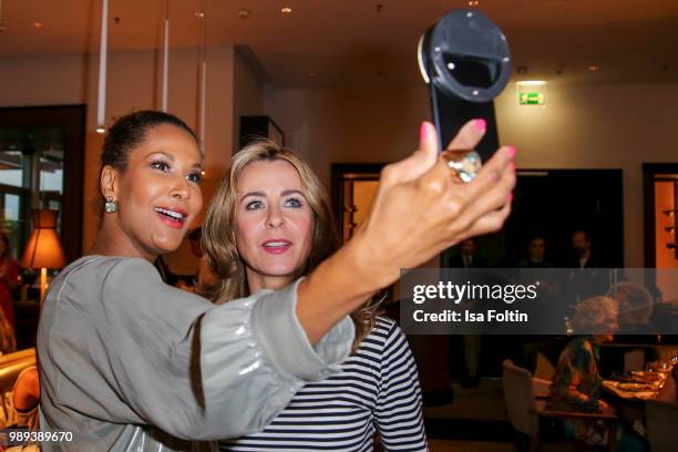 Model Marie Amiere and German presenter Bettina Cramer during the Ladies Dinner at Hotel De Rome on July 1, 2018 in Berlin, Germany.