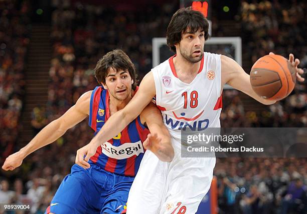 Milos Teodosic, #18 of Olympiacos Piraeus competes with Ricky Rubio, #9 of Regal FC Barcelona in action during the Euroleague Basketball Final Four...