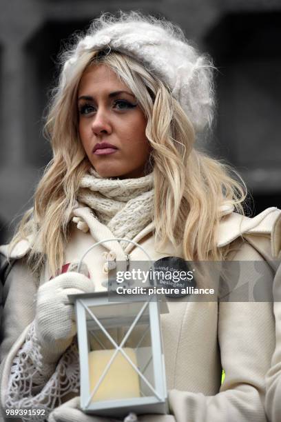 Young woman wears a button with an inscription reading "... And terrorism will not conquer us" during an expression of solidarity at the inauguration...