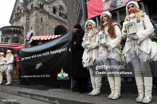 Proprietors display expression of solidarity at the inauguration of the memorial commemorating the victims of a terror attack on the Christmas market...