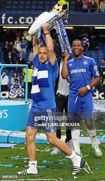 Chelsea's English midfielder Joe Cole celebrates with the Barclays Premier league trophy after they win the title with a 8-0 victory over Wigan...