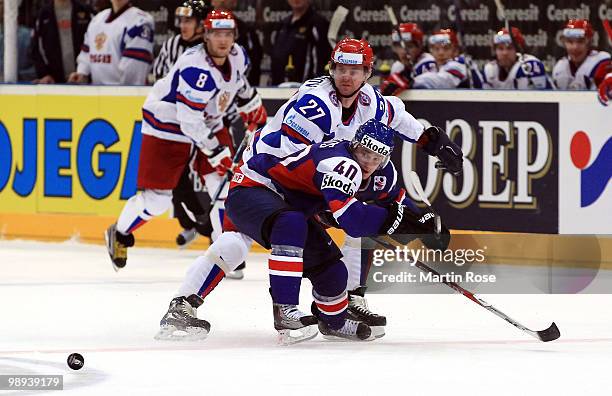 Marek Svatos of Slovakia and Vitaly Atyushov of Russia battle for the puck during the IIHF World Championship group A match between Slovakia and...
