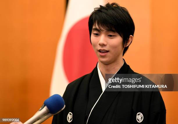 Japanese figure skater Yuzuru Hanyu receives a Q and A session with journalists following his People's Honor Award presentation ceremony at Japanese...