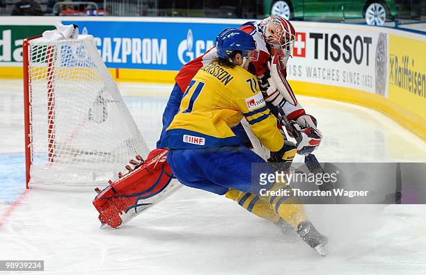Andersson of Sweden battles for the puck with Pal Grotnes of Norway during the IIHF World Championship group C match between Czech Republic and...