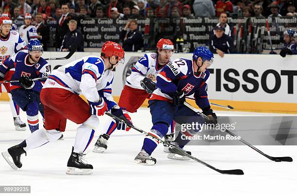 Ivan Ciernik of Slovakia and Dmitri Kalinin of Russia battle for the puck during the IIHF World Championship group A match between Slovakia and...