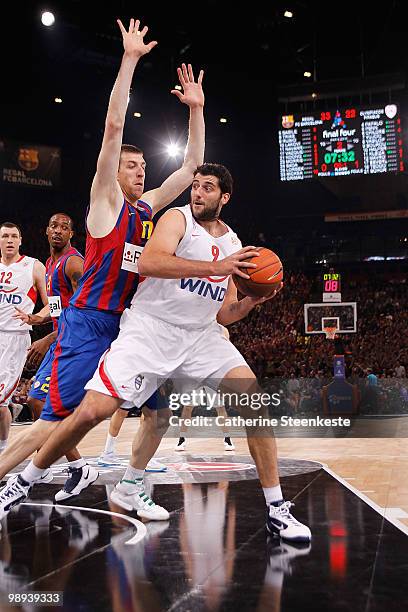 Ioannis Bourousis, #9 of Olympiacos Piraeus competes with Fran Vazquez, #17 of Regal FC Barcelona during the Euroleague Basketball Final Four Final...
