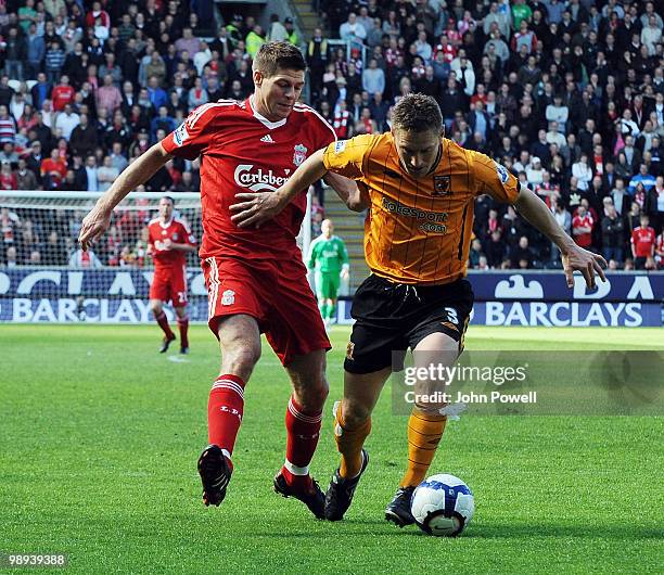 Steven Gerrard of Liverpool competes with Andy Dawson of Hull City during the Barclays Premier League match between Hull City and Liverpool at KC...