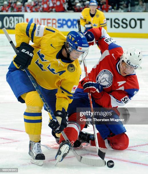 Carl Gunnarsson of Sweden battles for the puck with Kristian Forsberg of Norway during the IIHF World Championship group C match between Czech...