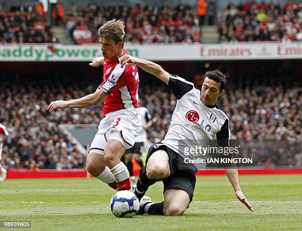 Arsenal's Russian player Andrey Arshavin vies with Fulham's Irish defender Stephen Kelly during the English Premier League football match between...