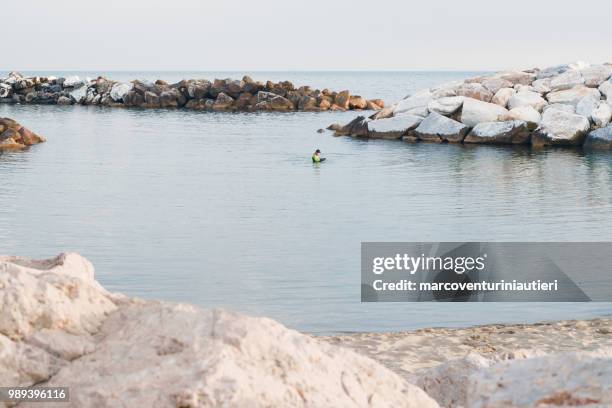 distant scuba diver in the sea - marcoventuriniautieri stock pictures, royalty-free photos & images