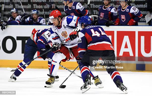 Andrej Sekera of Slovakia and Alexander Ovechkin of Russia battle for the puck during the IIHF World Championship group A match between Slovakia and...