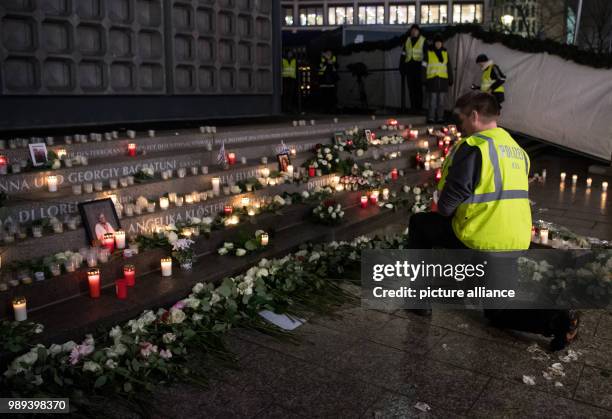 Police officer kneels at the memorial commemorating the victims of the terror attack one year ago at the Christmas market on Breitscheidsplatz in...