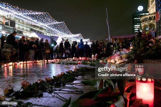 Several people come to the memorial commemorating the victims of the terror attack one year ago at the Christmas market on Breitscheidsplatz in...