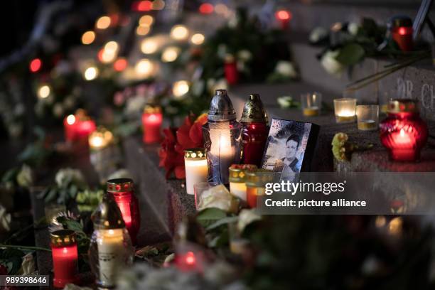 Photographs of the victims are placed at the memorial commemorating the victims of the terror attack one year ago at the Christmas market on...