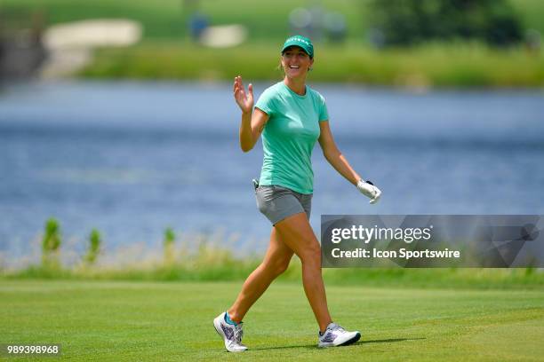 Jaye Marie Green waves to the crowd as she approaches the 18th hole during the final round of the KPMG Women's PGA Championship on July 1, 2018 at...