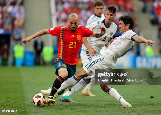 David Silva of Spain and Yuri Zhirkov of Russia compete for the ball during the 2018 FIFA World Cup Russia Round of 16 match between Spain and Russia...